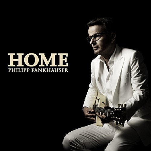 Man in white suit holding guitar, album cover "Home" by Philipp Fankhauser.