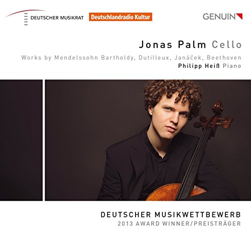 A man in a black shirt holds a cello, against a dark background.
