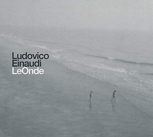 "Album cover with a black and white beach scene and artist's name."