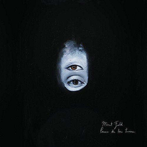 A vinyl record cover featuring a face with eyes staring forward on a black background.