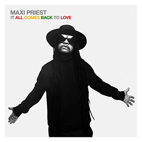 The image is a black-and-white photograph of a man wearing a hat and sunglasses, with his arms outstretched. Alt text: Man in black outfit and hat with outstretched arms on album cover.