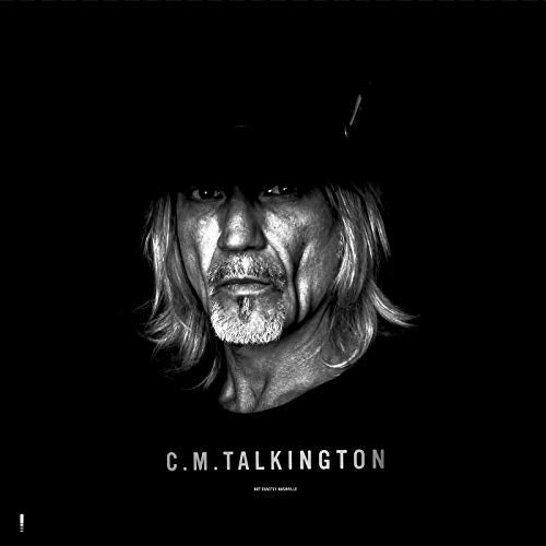 Black-and-white album cover featuring a man with long hair and a hat.