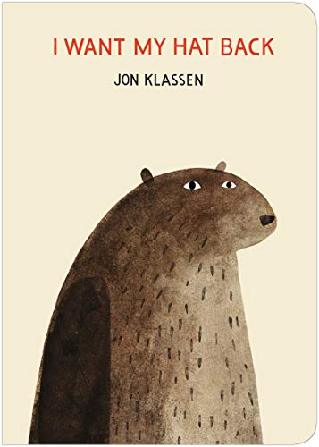 "Children's book cover featuring a bear with a beige background and red title text."