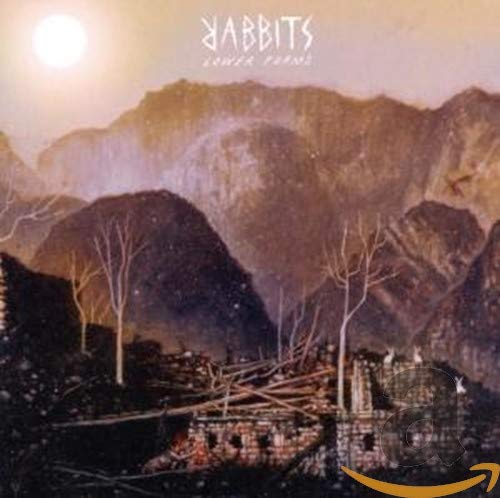 "Album cover art with a mountain landscape, full moon, and destroyed building."