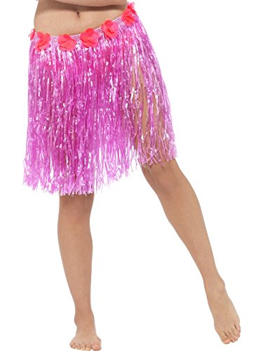 A woman wears a pink hula skirt with tassels and red flowers.