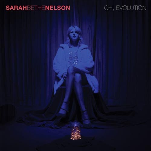 Album cover: woman sitting on a chair, surrounded by dark curtains, with a lit lantern.