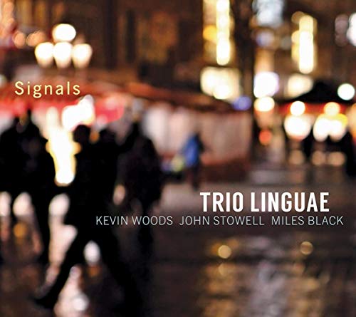 Blurry city street scene at night with silhouetted people and "Signals" and "Trio Linguae" text.