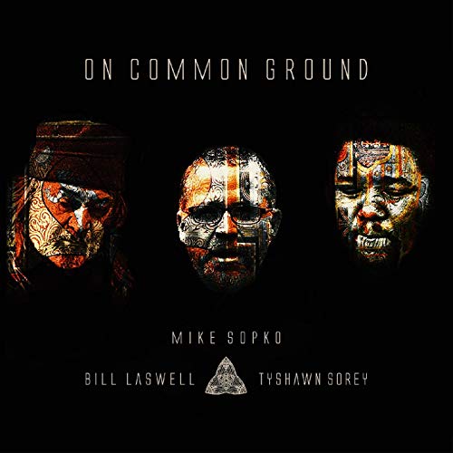 "Album cover with three masked faces and names on a black background."