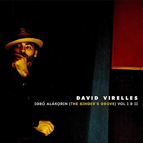 "Album cover with a man in a hat, hand on chin, against a dark background."