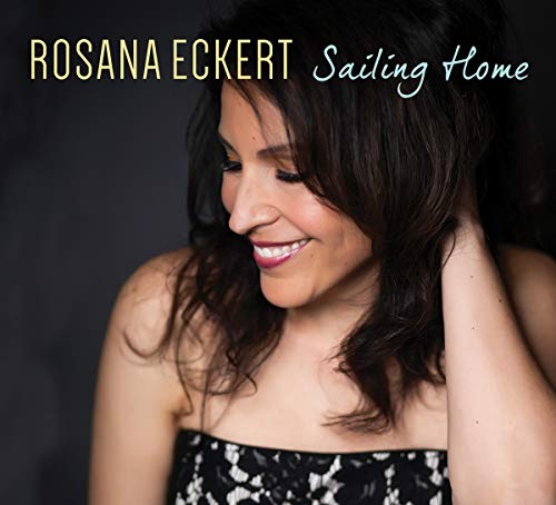 "CD cover featuring a smiling woman with dark hair and a black floral top."
