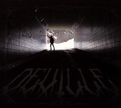"Album cover featuring a person standing in a dimly lit tunnel with bright exit."