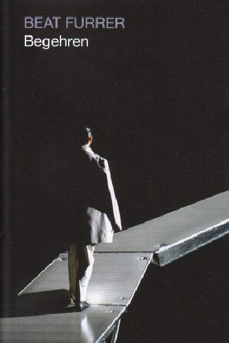 The image is a DVD cover for "Begehren" by Beat Furrer. A man, dressed in a black shirt and white pants, is standing on a gray surface, gazing upwards with his head tilted back. The background is solid black, with the title "BEAT FURRER" and "Begehren" written in white text at the top left corner. For accessibility purposes, a concise descriptive alt text for this image could be: "DVD cover with man
