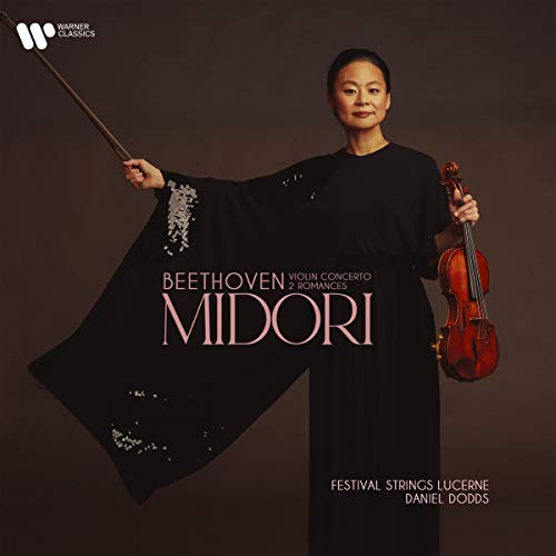 A woman in a black dress holds a violin and bow against a brown background.