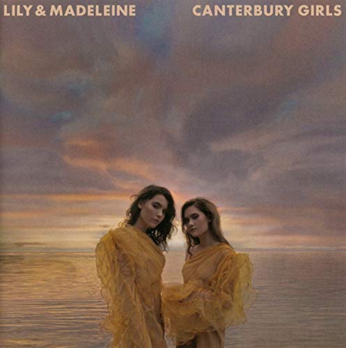 "Album cover featuring two women in yellow dresses standing together by water."