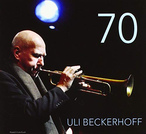 "Album cover featuring a man playing a trumpet under a stage light."