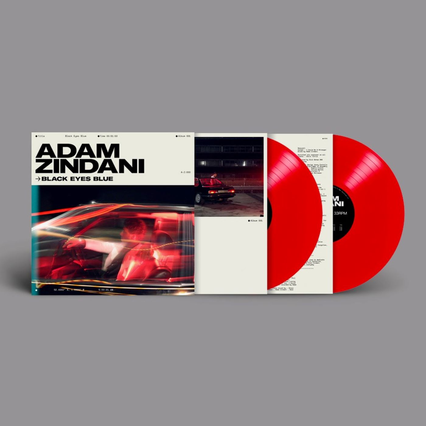 "Red vinyl record with sleeve featuring 'Adam Zindani - Black Eyes Blue' album artwork."