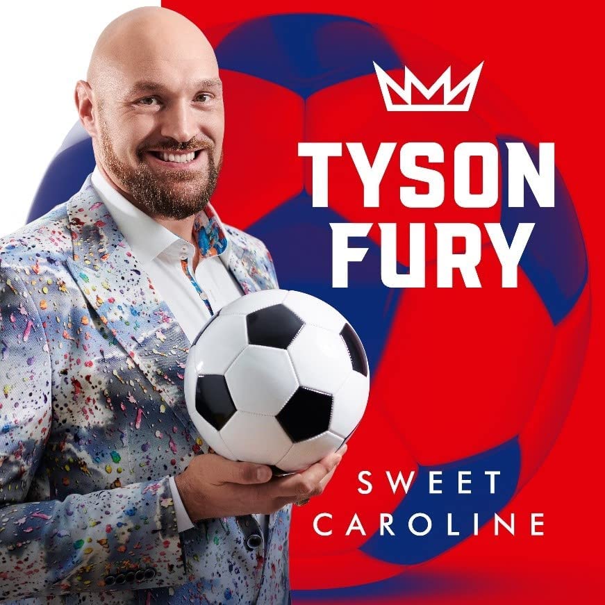 Boxer Tyson Fury holding a soccer ball, wearing a paint-splattered suit.