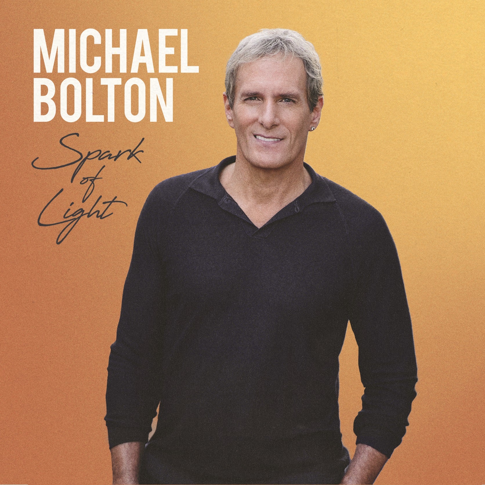 "Album cover for 'Spark of Light' by Michael Bolton, featuring a man in a black shirt."