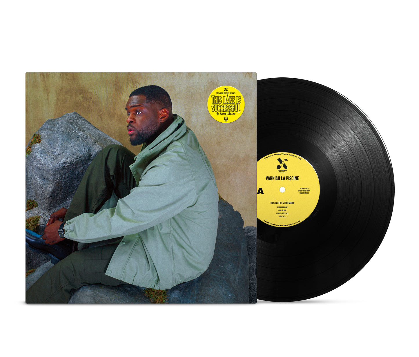Vinyl record with cover art of a man sitting on rocks.
