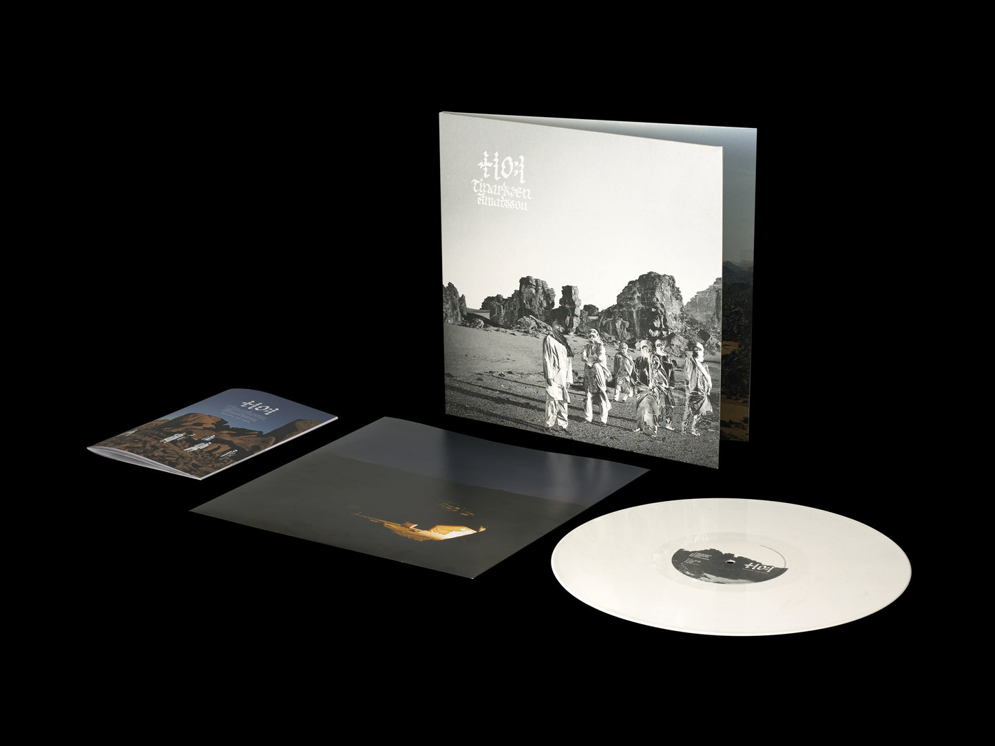 White vinyl record and album cover with black and white desert image.
