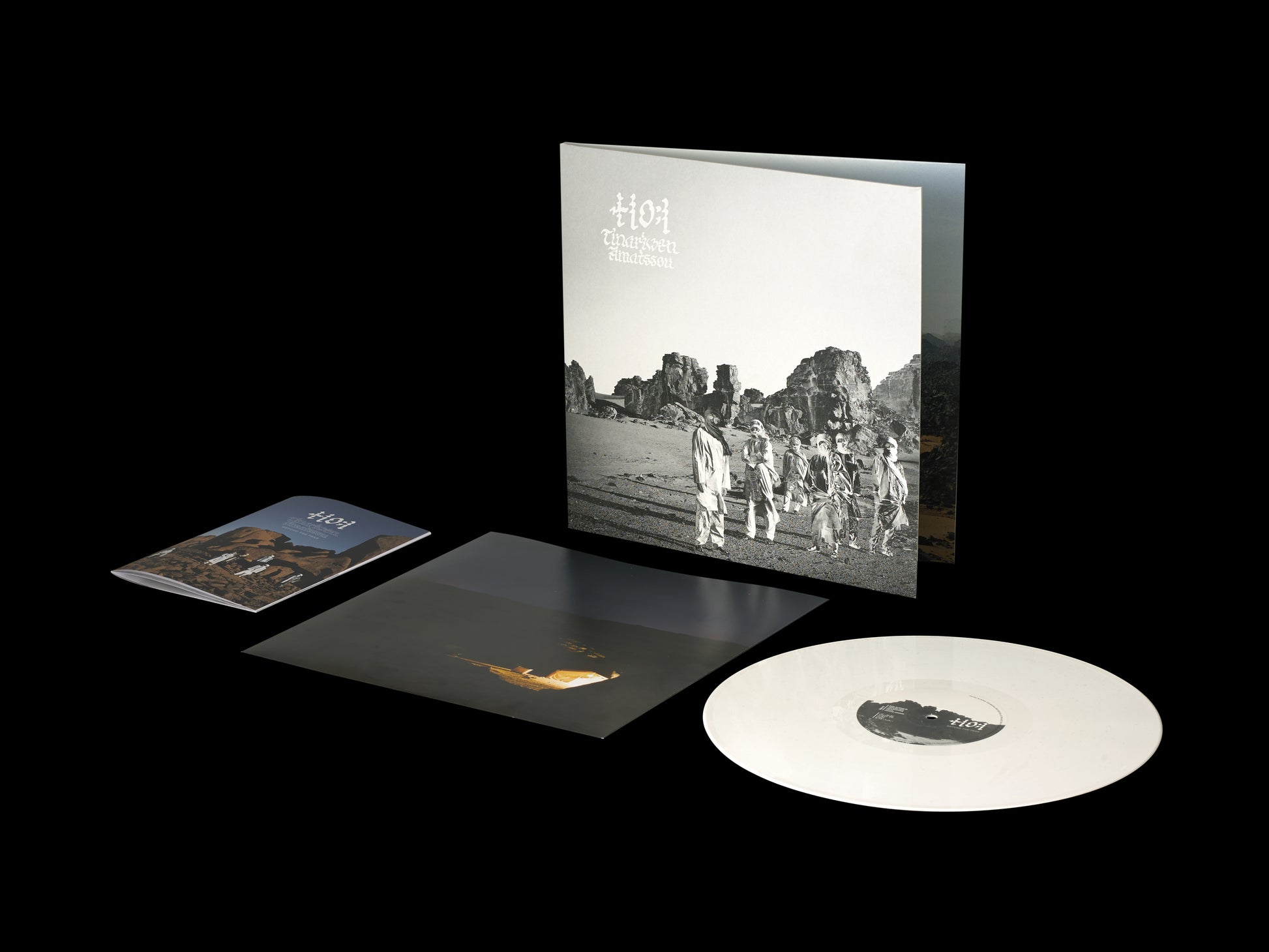White vinyl record and album cover with black and white desert image.