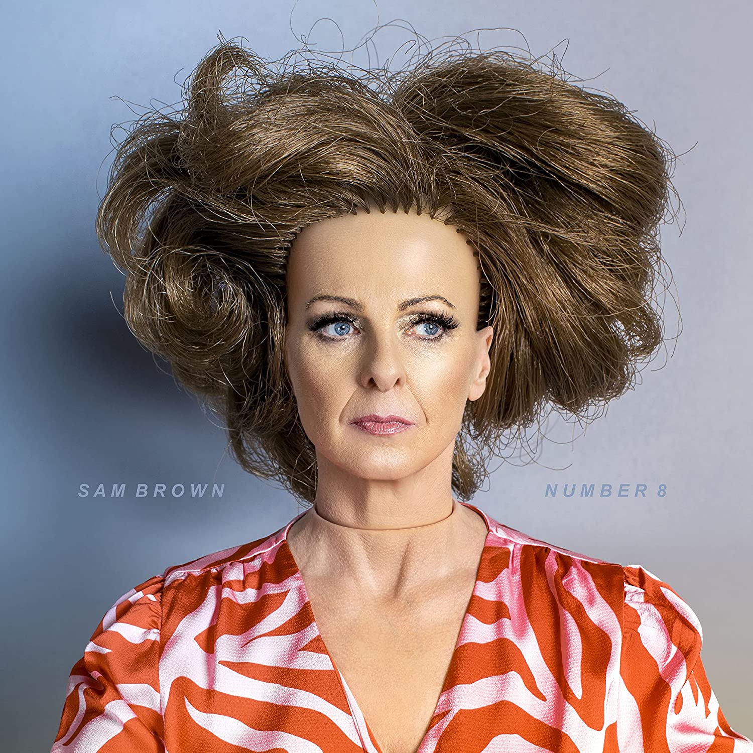 "Album cover featuring a woman with messy hair and orange zebra print top."