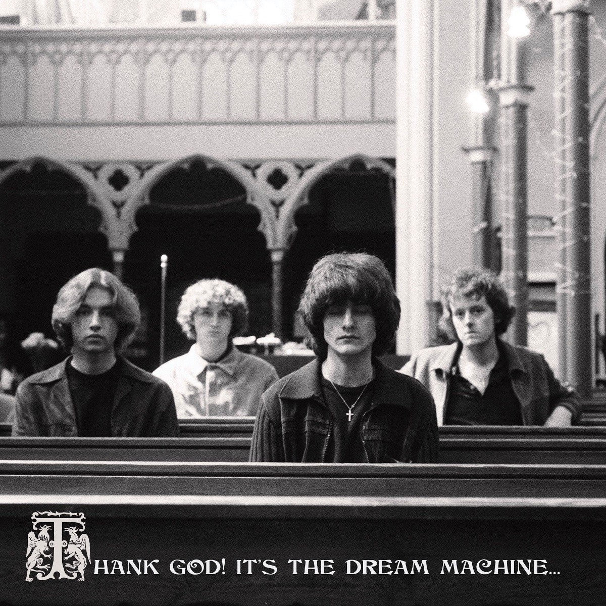 "Black and white vinyl album cover featuring a band in a church pew."