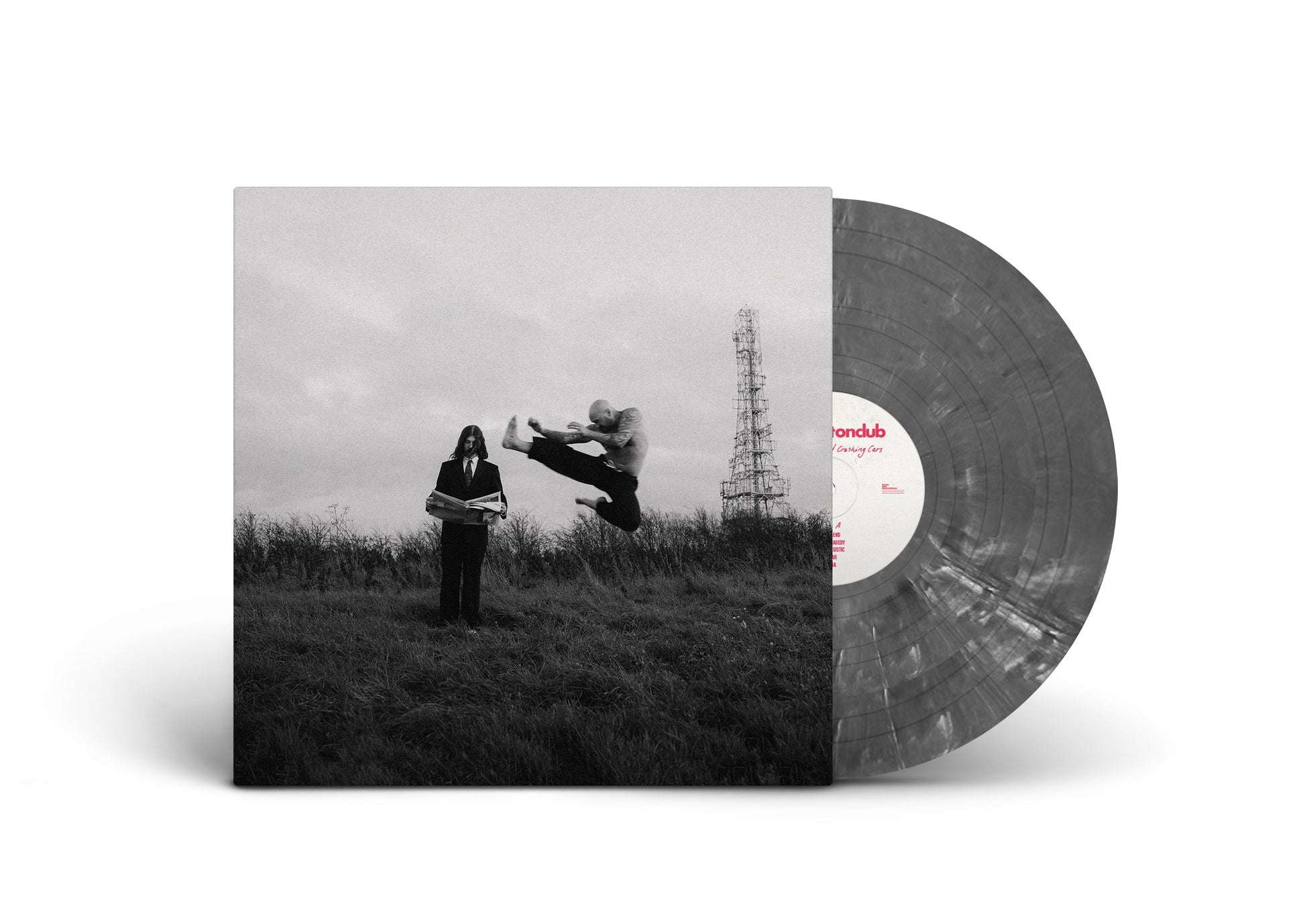 "Vinyl record with grey marbled disc and black-and-white album cover featuring a surreal scene."