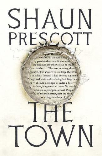 "Book cover of 'The Town' by Shaun Prescott, with torn paper and text."