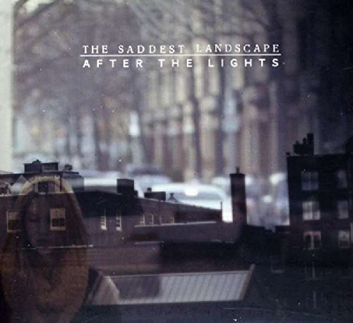 "Album cover with a blurry cityscape at dusk and white text."