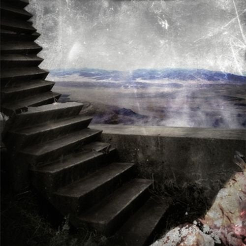 The image depicts a surreal landscape with a staircase leading to a vast, cloudy terrain. For accessibility purposes, a concise alt text could be: "Vinyl record cover with staircase and cloudy landscape."