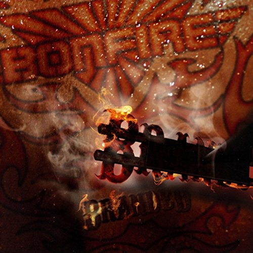 A flaming gun is in the foreground, with graffiti in the background.
