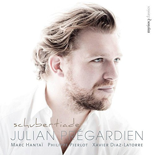 The image is a close-up of a man's face, with the title "schubertiad" written at the bottom. * The man is wearing a white shirt and has short, light-brown hair. * He is looking to his right, with a slight smile on his face. * The background is white, with some text at the bottom that reads: + "schubertiade" in small, gray letters + "JULIAN PREGARDIEN" in larger