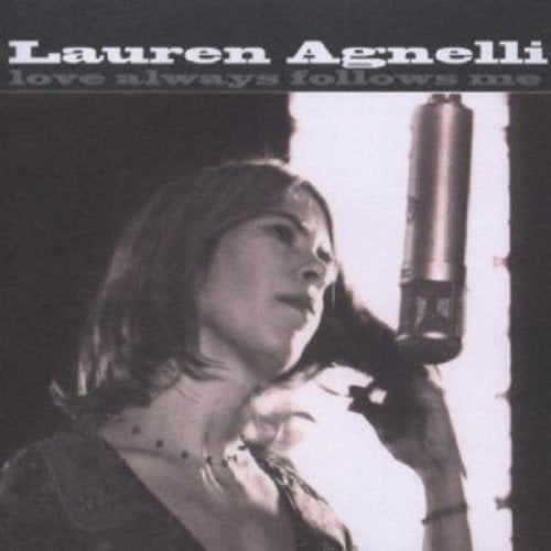 "Album cover with black and white photo of woman holding a microphone."