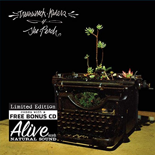 "Album cover featuring a vintage typewriter with plants growing out of it."
