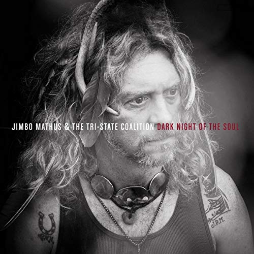 Black and white album cover featuring a man with long hair, horns, and tattoos.