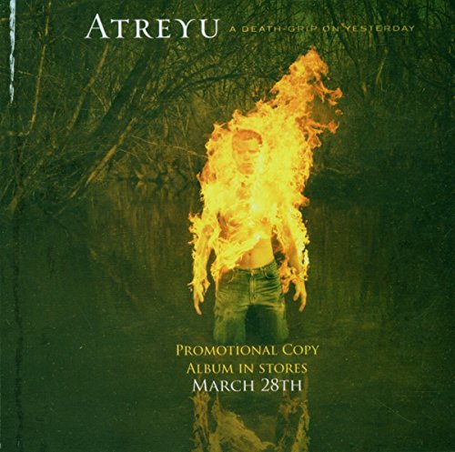 Atreyu album cover with a person engulfed in flames standing in dark water.