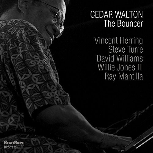 Black and white image of a man playing piano on a CD cover.