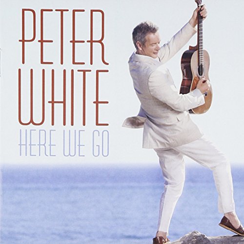 "Album cover with a man in white holding a guitar on a rocky seaside."