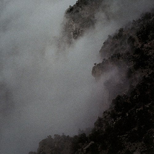 The image depicts a CD case. The concise, descriptive alt text is: "CD case with a dark, foggy mountain landscape."