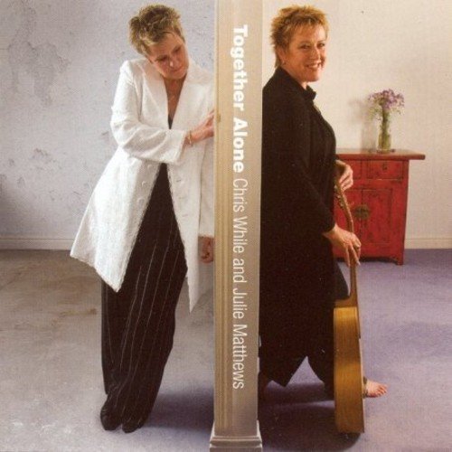 "CD cover featuring two smiling women, one holding a cello, standing beside a pillar."