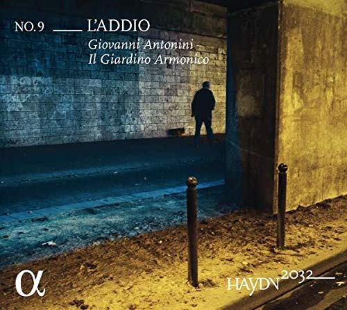 "CD cover art: man standing by a brick wall, with text overlays."