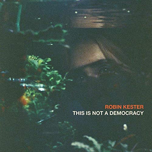 "Album cover with a dark, blurry image and text 'Robin Kester - This Is Not A Democracy'."