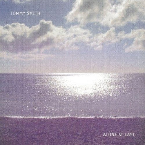"Album cover with a serene seascape, reflecting sunlight, with artist and title text."
