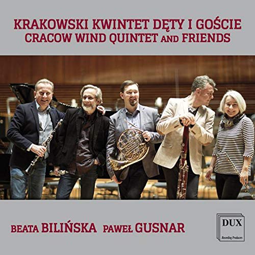 "CD cover featuring five musicians with various instruments, smiling and standing together."