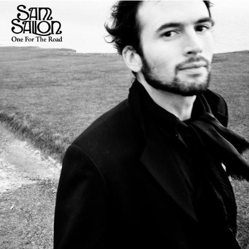 Black and white album cover featuring a man in a dark jacket and open shirt.