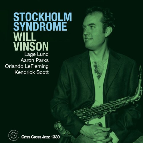 Man in a suit holding a saxophone, album cover with artist and title.