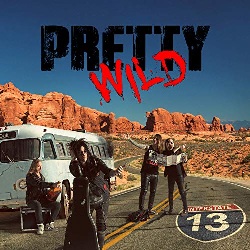 "Pretty Wild" album cover featuring three musicians on a desert road with a tour bus.
