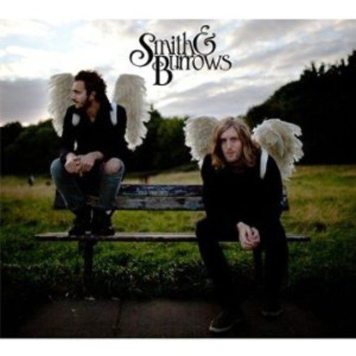 "Album cover featuring two men with white angel wings sitting on a bench outdoors."