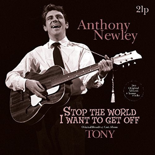 Black-and-white image of man singing and playing guitar on a black album cover.